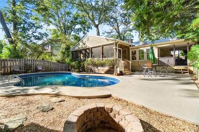 view of pool featuring a sunroom and a patio