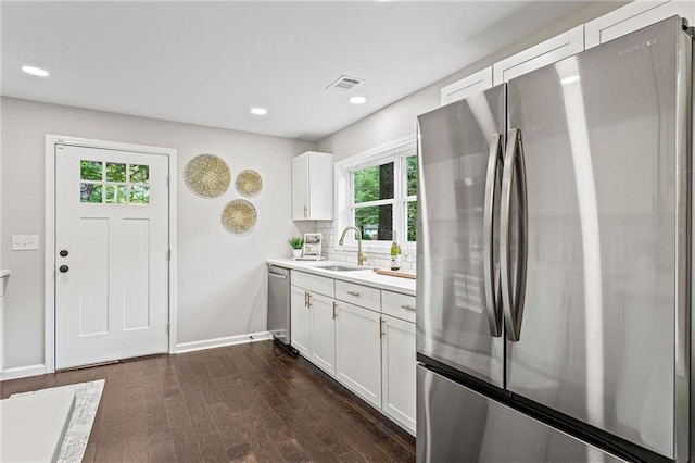 kitchen with stainless steel appliances, white cabinets, light countertops, and a sink