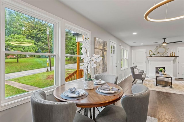 sunroom / solarium featuring a fireplace and ceiling fan