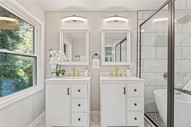 full bath featuring marble finish floor, two vanities, and a sink