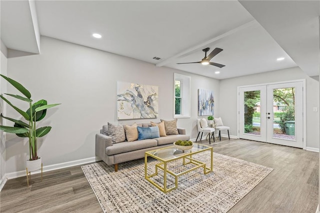 living room featuring a wealth of natural light, wood finished floors, visible vents, and recessed lighting