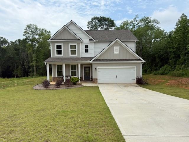 50 Scout Hut Rd, Danielsville, GA 30633 - craftsman house featuring driveway, covered porch, a front lawn, a garage, and board and batten siding