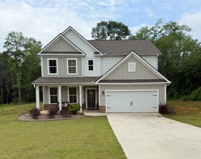 50 Scout Hut Rd, Danielsville, GA 30633 - craftsman-style house featuring concrete driveway, a front yard, a porch, roof with shingles, and an attached garage
