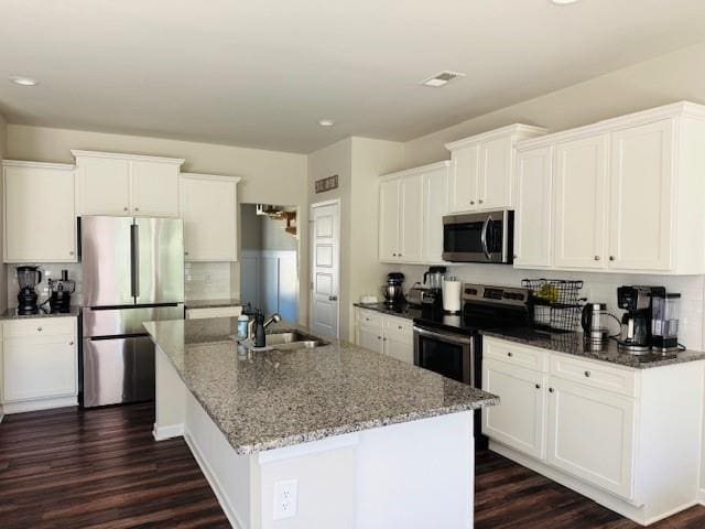 50 Scout Hut Rd, Danielsville, GA 30633 - kitchen with appliances with stainless steel finishes, a sink, dark wood-style flooring, a center island with sink, and recessed lighting
