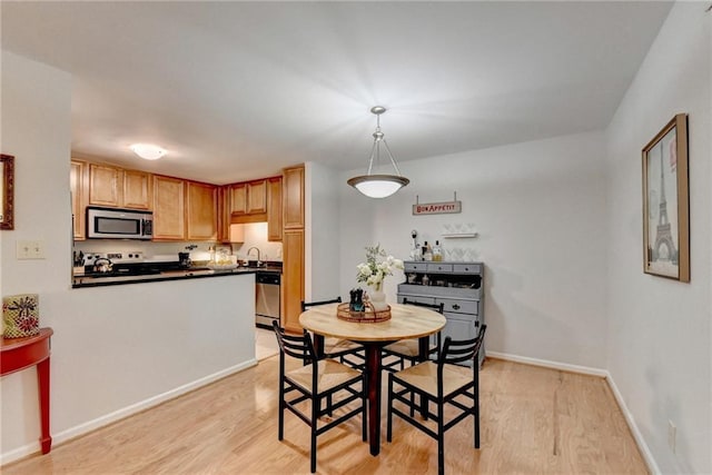 dining area featuring light hardwood / wood-style floors and sink