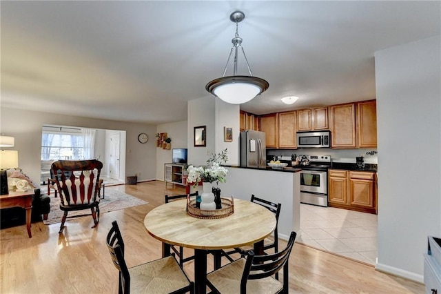 dining space with light hardwood / wood-style floors