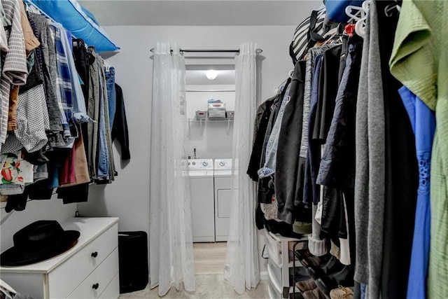 spacious closet featuring washer and clothes dryer