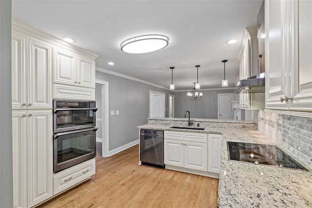 kitchen with black appliances, white cabinetry, and sink