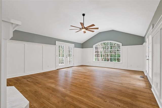 unfurnished living room featuring ceiling fan, plenty of natural light, light hardwood / wood-style flooring, and french doors