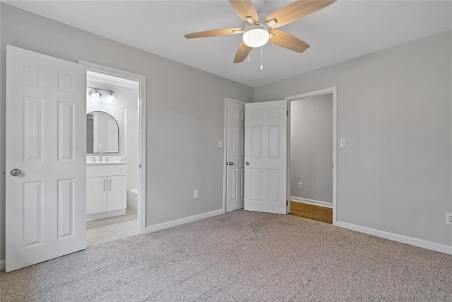 unfurnished bedroom with connected bathroom, light colored carpet, ceiling fan, and sink