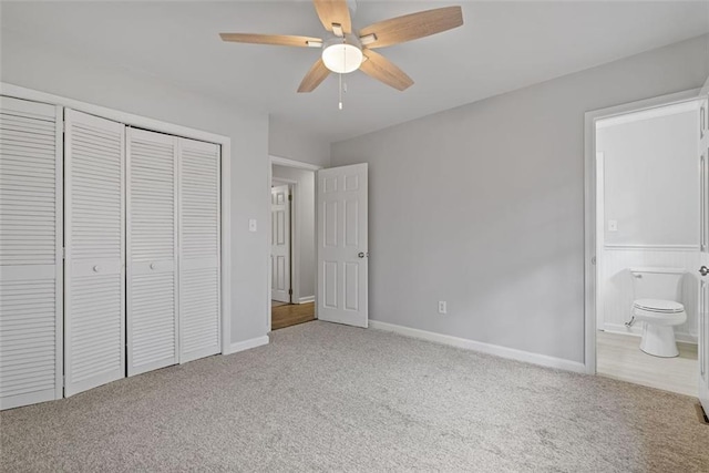 unfurnished bedroom featuring carpet, ceiling fan, ensuite bath, and a closet