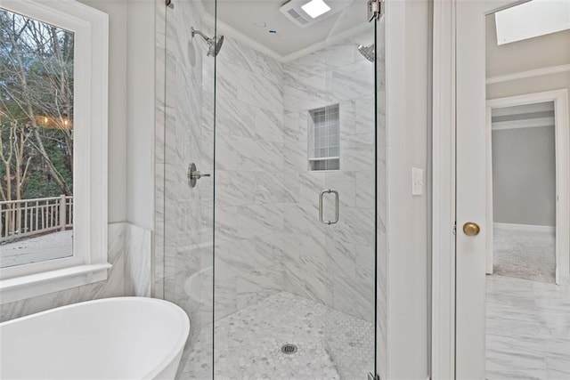 bathroom with crown molding and shower with separate bathtub