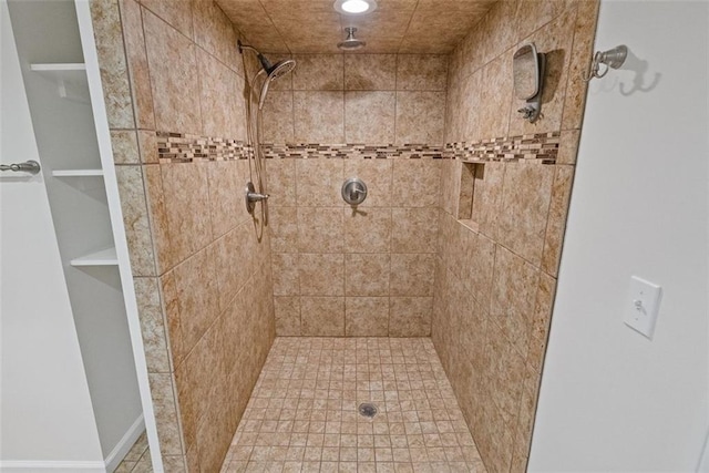 bathroom with tiled shower