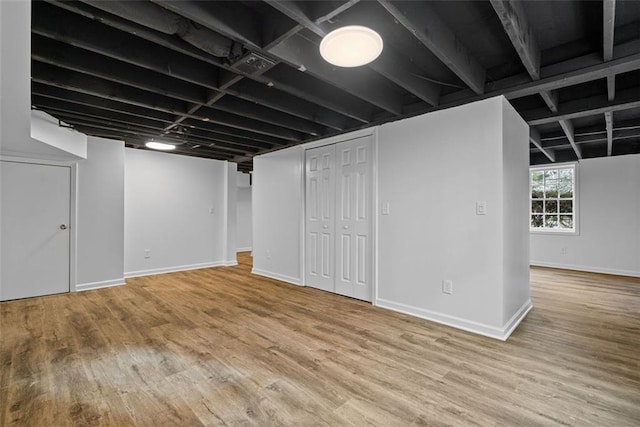 basement with hardwood / wood-style flooring