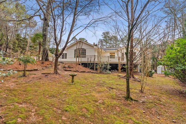 rear view of house featuring a wooden deck