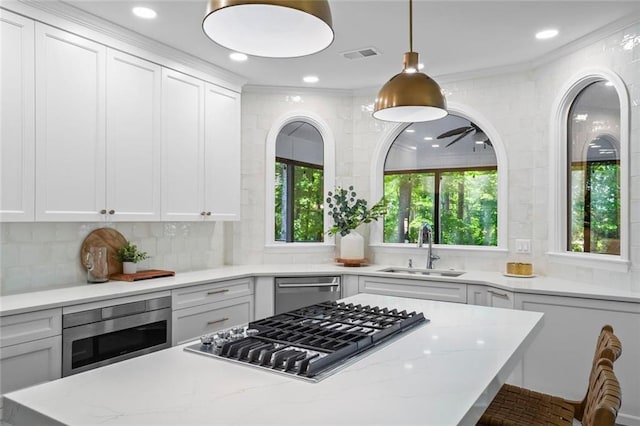605 Linkside Holw, Alpharetta, GA 30005 - kitchen featuring stainless steel appliances, white cabinetry, a center island, light stone counters, and recessed lighting