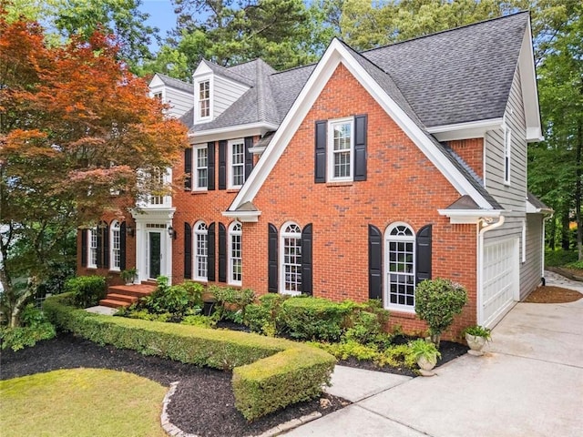 605 Linkside Holw, Alpharetta, GA 30005 - colonial house featuring concrete driveway, brick siding, a shingled roof, and a garage