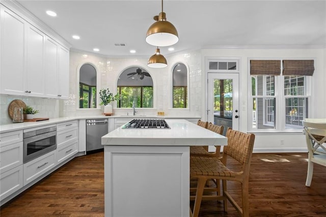 605 Linkside Holw, Alpharetta, GA 30005 - kitchen with stainless steel appliances, crown molding, a kitchen bar, light countertops, and a kitchen island