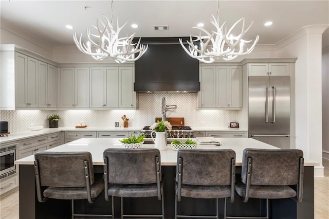 132 Grand Cres, Alpharetta, GA 30009 - kitchen featuring a chandelier, built in appliances, ventilation hood, light countertops, and crown molding
