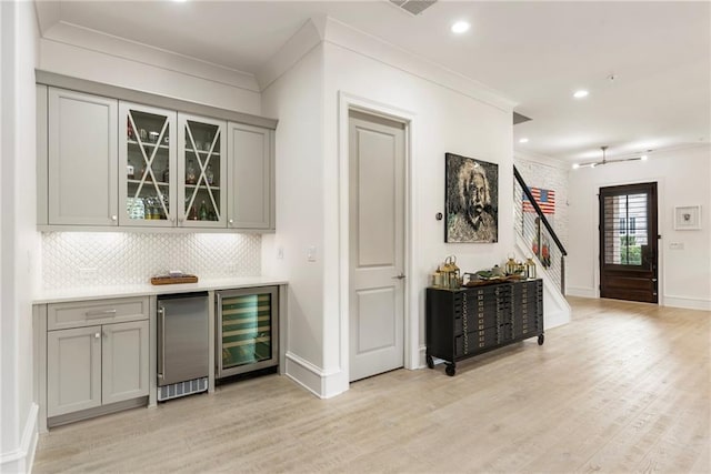 132 Grand Cres, Alpharetta, GA 30009 - indoor dry bar with wine cooler, crown molding, stairs, tasteful backsplash, and light wood-type flooring