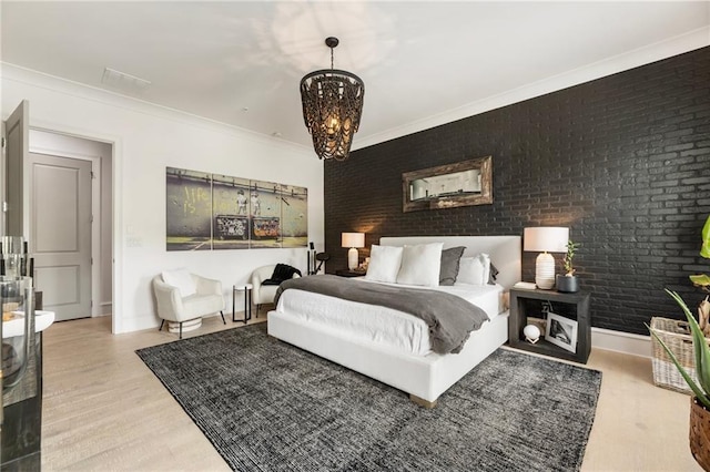 132 Grand Cres, Alpharetta, GA 30009 - bedroom with wood finished floors, a chandelier, brick wall, and crown molding