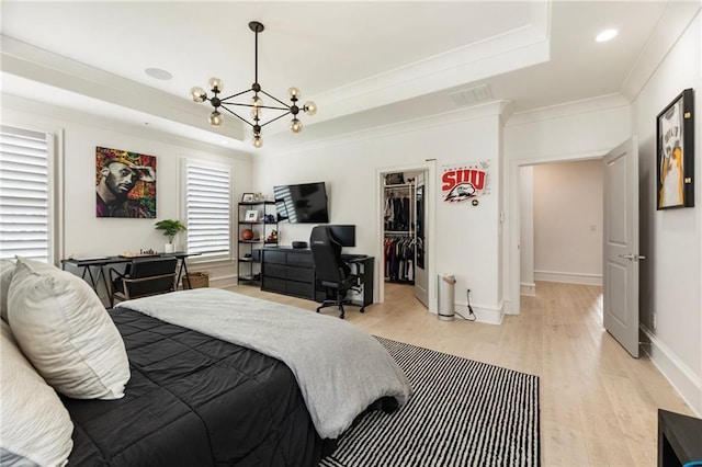 132 Grand Cres, Alpharetta, GA 30009 - bedroom featuring a raised ceiling, a chandelier, light wood finished floors, ornamental molding, and a spacious closet
