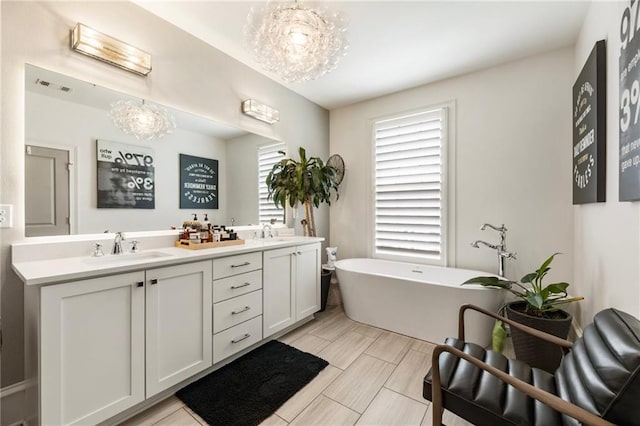 132 Grand Cres, Alpharetta, GA 30009 - full bath featuring a freestanding tub, double vanity, and a chandelier