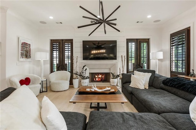 132 Grand Cres, Alpharetta, GA 30009 - living room with wood finished floors, a warm lit fireplace, and recessed lighting
