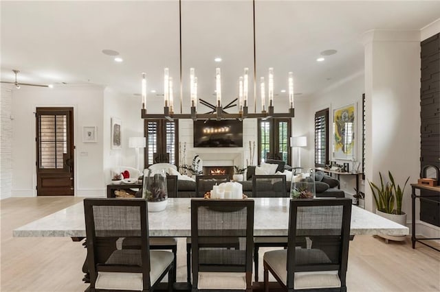 132 Grand Cres, Alpharetta, GA 30009 - dining room with a lit fireplace, light wood-type flooring, and recessed lighting