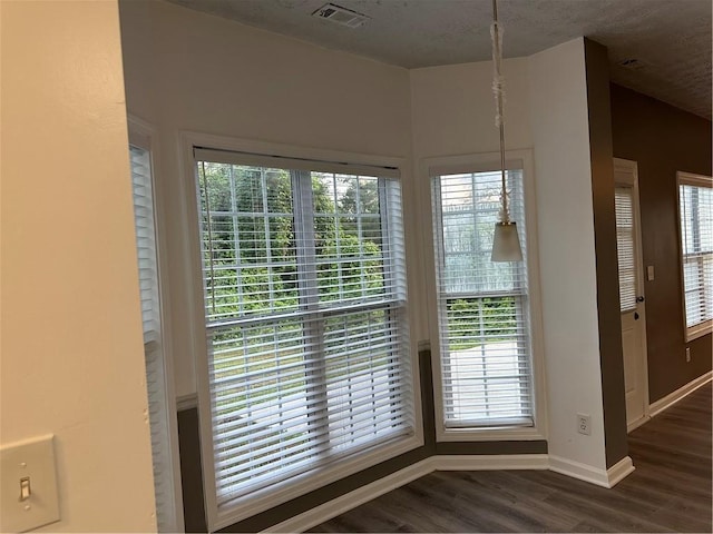 interior details with wood-type flooring and a textured ceiling