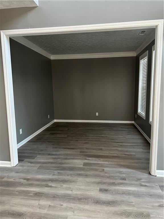 spare room featuring ornamental molding and hardwood / wood-style floors