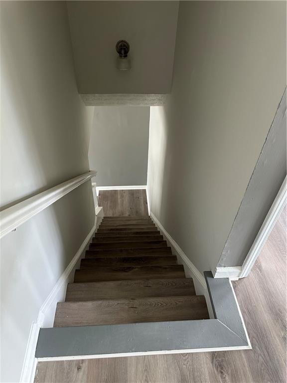 stairs featuring hardwood / wood-style floors