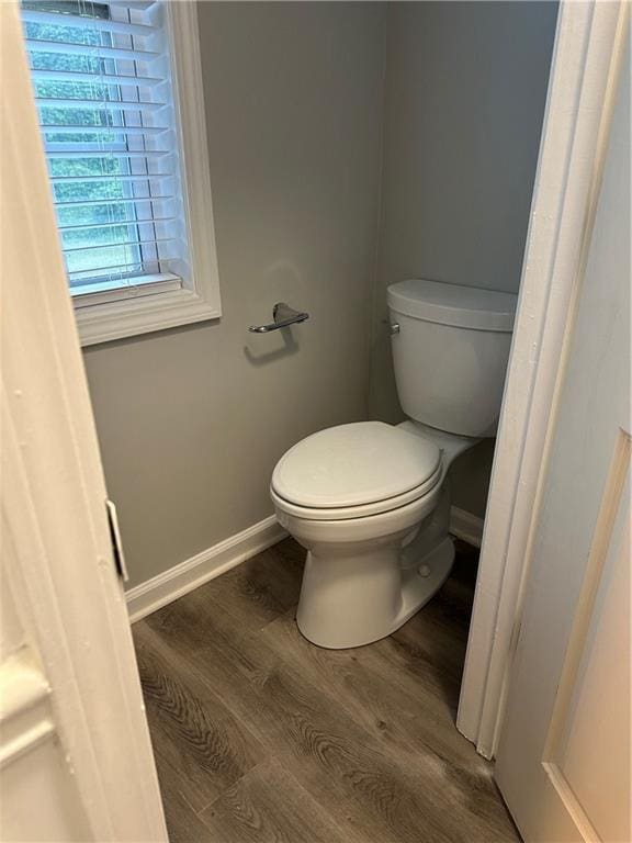 bathroom with hardwood / wood-style flooring and toilet