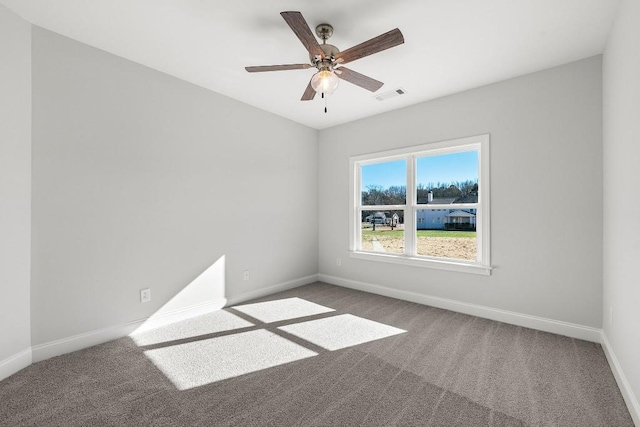 unfurnished room featuring ceiling fan, carpet flooring, visible vents, and baseboards