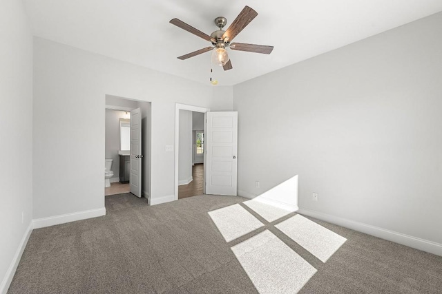 unfurnished bedroom featuring light carpet, a ceiling fan, baseboards, and connected bathroom