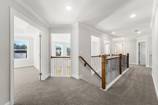 hallway with carpet floors, recessed lighting, ornamental molding, and an upstairs landing