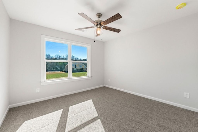 empty room with carpet, ceiling fan, and baseboards