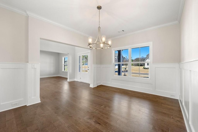 unfurnished dining area featuring dark wood-type flooring, plenty of natural light, and an inviting chandelier