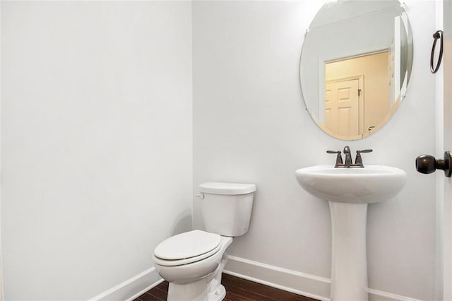 bathroom featuring hardwood / wood-style flooring and toilet