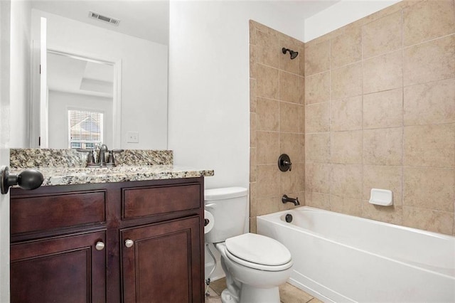 full bathroom featuring tile patterned floors, tiled shower / bath combo, toilet, and vanity