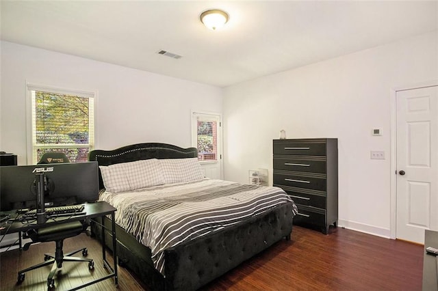 bedroom with dark wood-type flooring