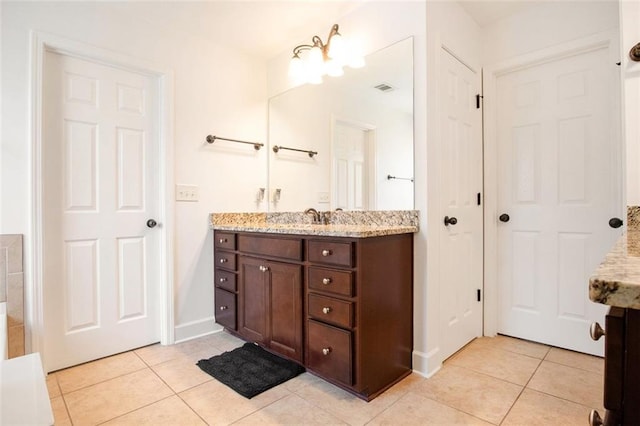 bathroom with tile patterned flooring and vanity