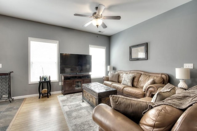 living room with a wealth of natural light, ceiling fan, and light hardwood / wood-style floors