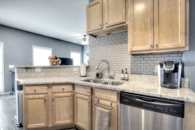 kitchen featuring dishwasher, light stone counters, kitchen peninsula, sink, and ceiling fan