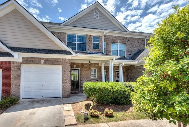 view of front of home featuring concrete driveway, brick siding, roof with shingles, and an attached garage