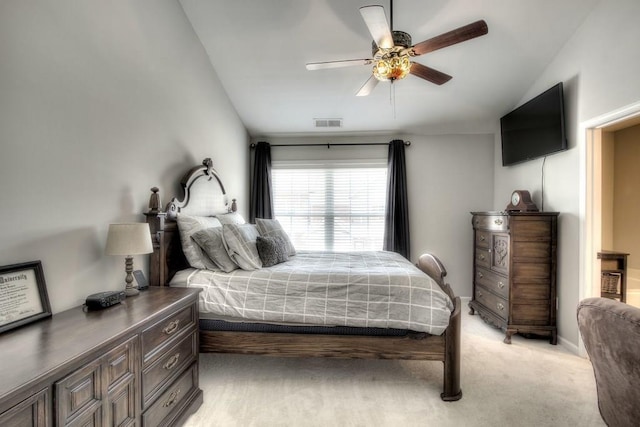 bedroom featuring ceiling fan, light carpet, and vaulted ceiling