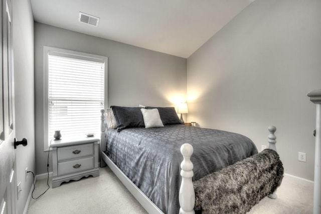 bedroom with lofted ceiling and light colored carpet