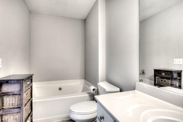 bathroom with toilet, a garden tub, and vanity