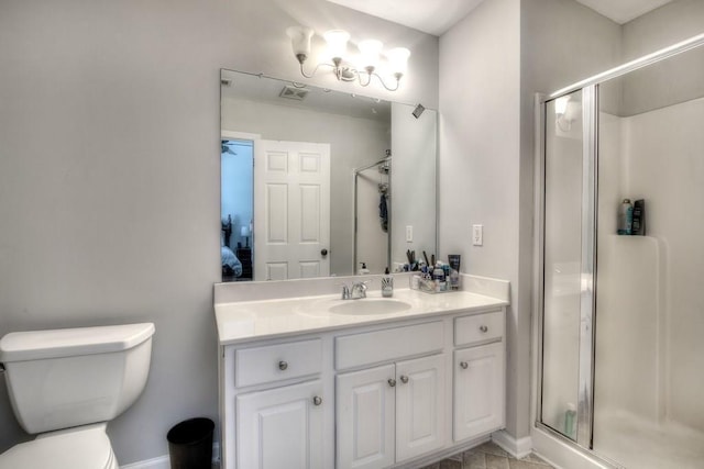 bathroom featuring toilet, an enclosed shower, and vanity