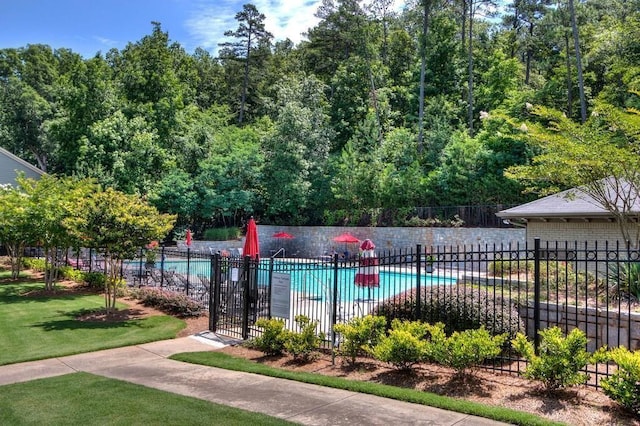 view of pool featuring a lawn